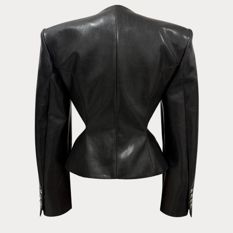 Black leather cropped jacket shown from the back, featuring structured shoulders, a defined waist, and button details on the cuffs, set against a light gray background.