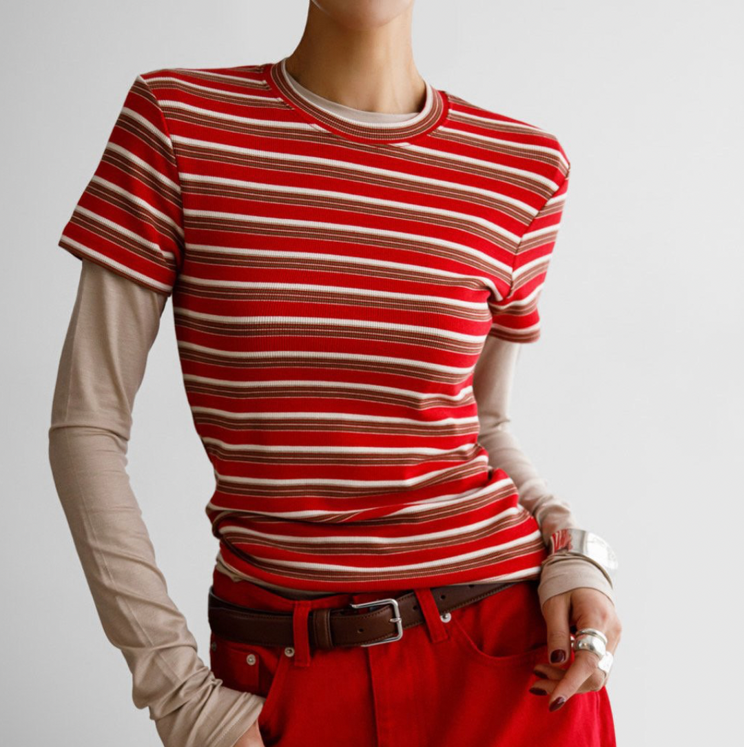 Mannequin wearing a red and white striped shirt and red pants on a gray background